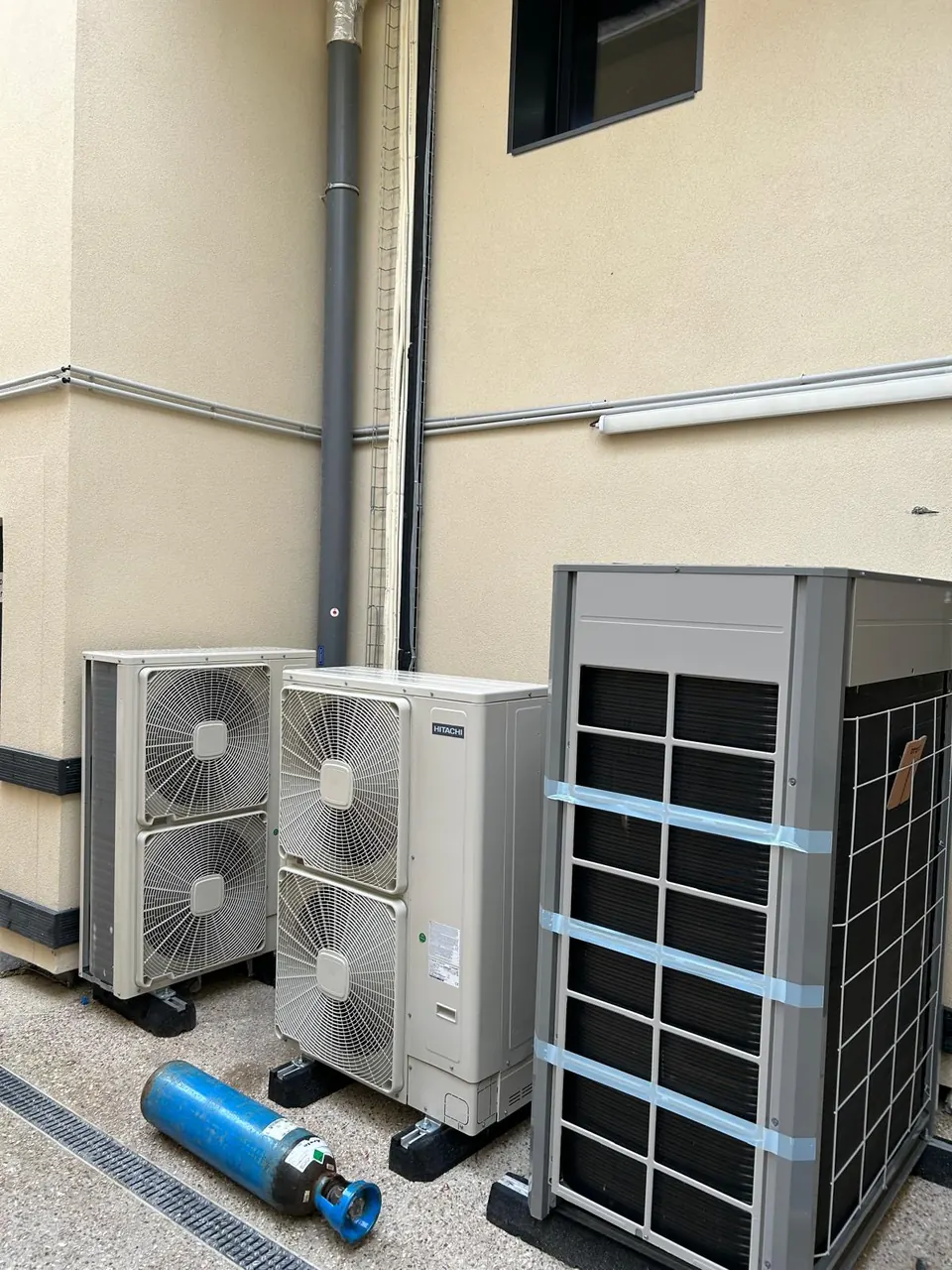 Several outdoor air conditioning units installed on a facade